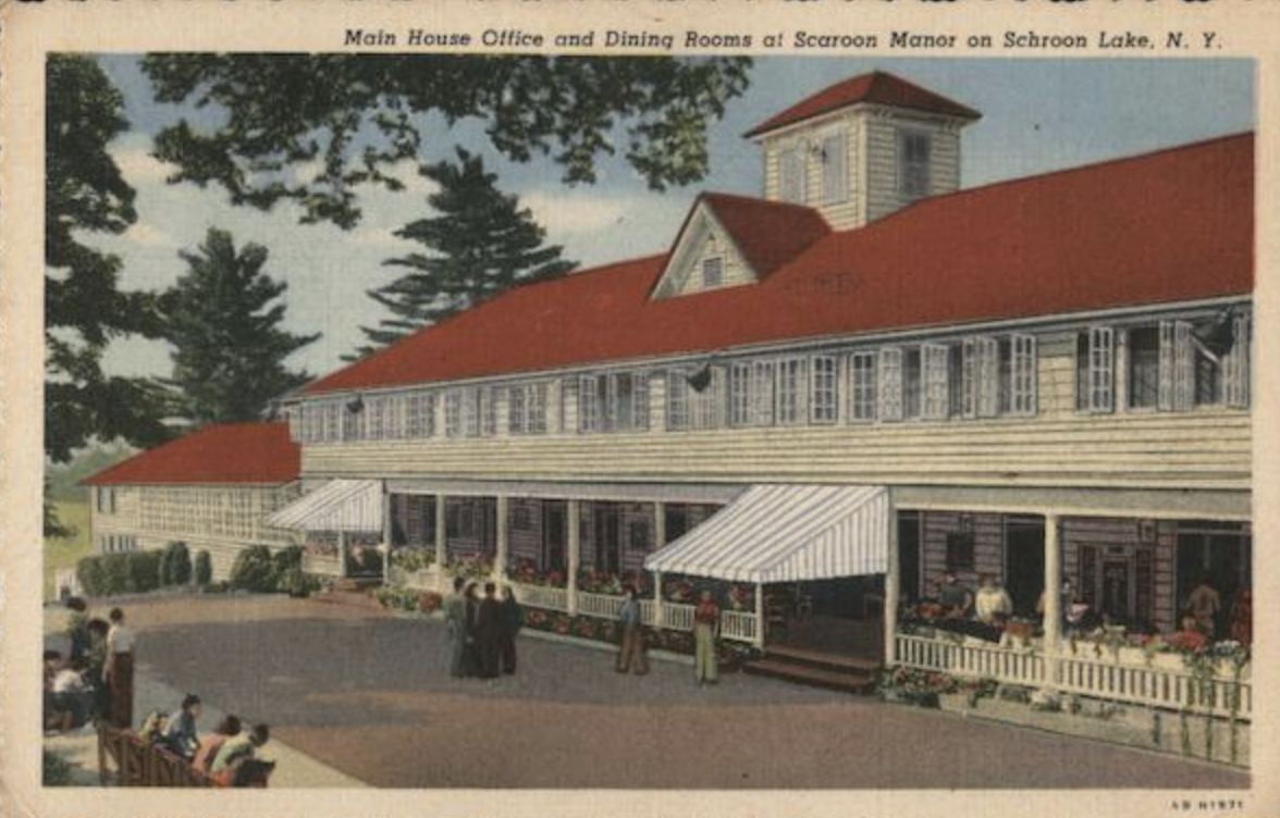 An old fashioned color postcard of a retro Adirondack resort building.
